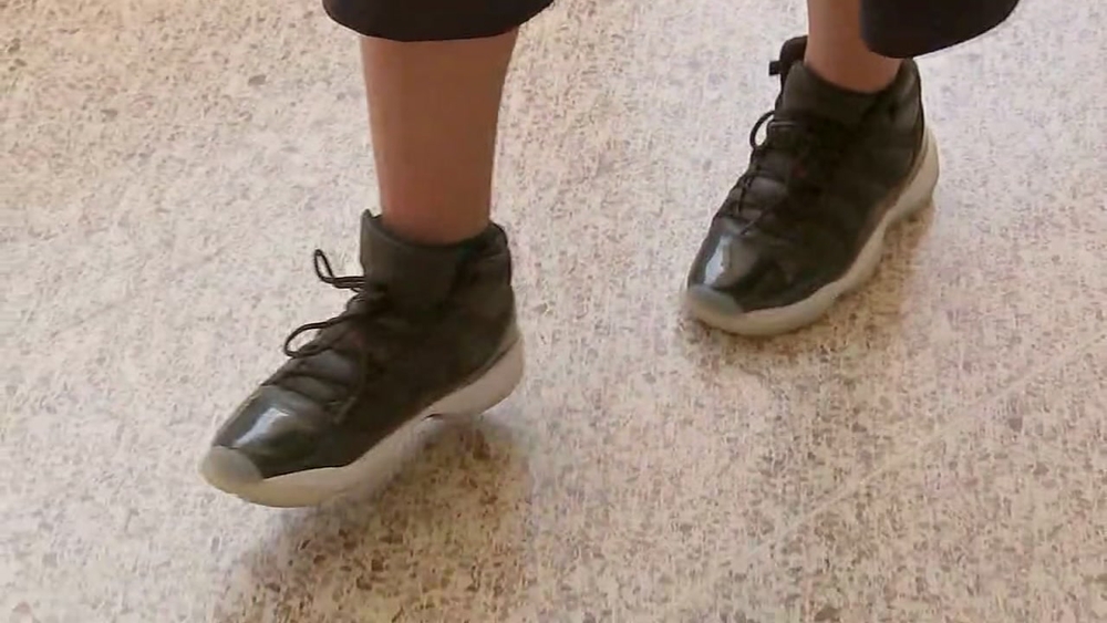 Middle schooler gives shoes to classmate